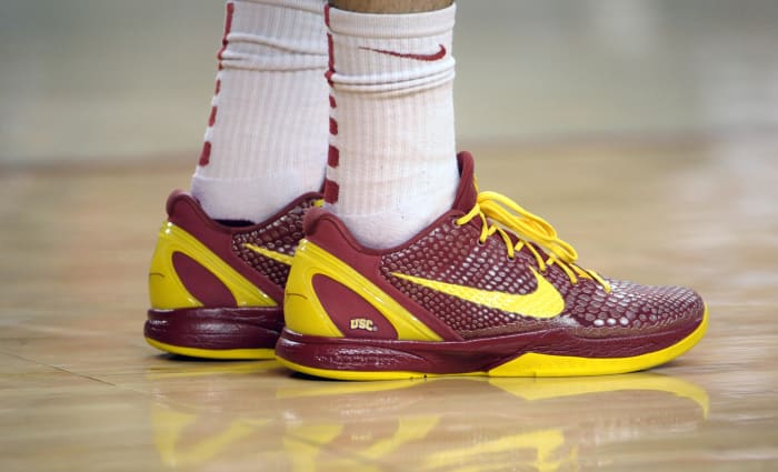 View of cardinal and gold Nike Kobe shoes.